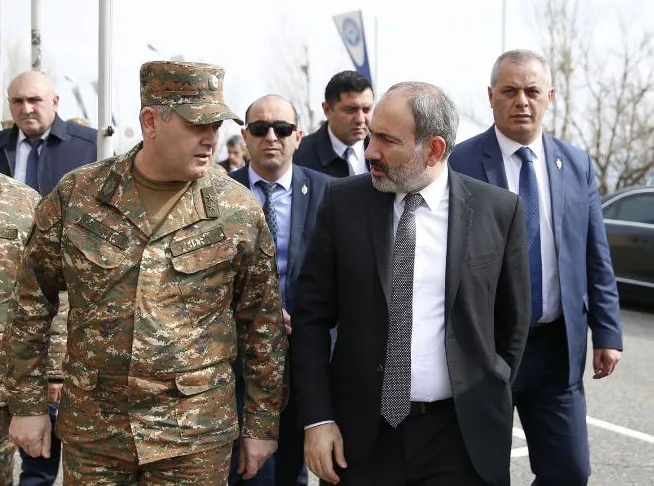 A head of state accompanied by security detail at an event